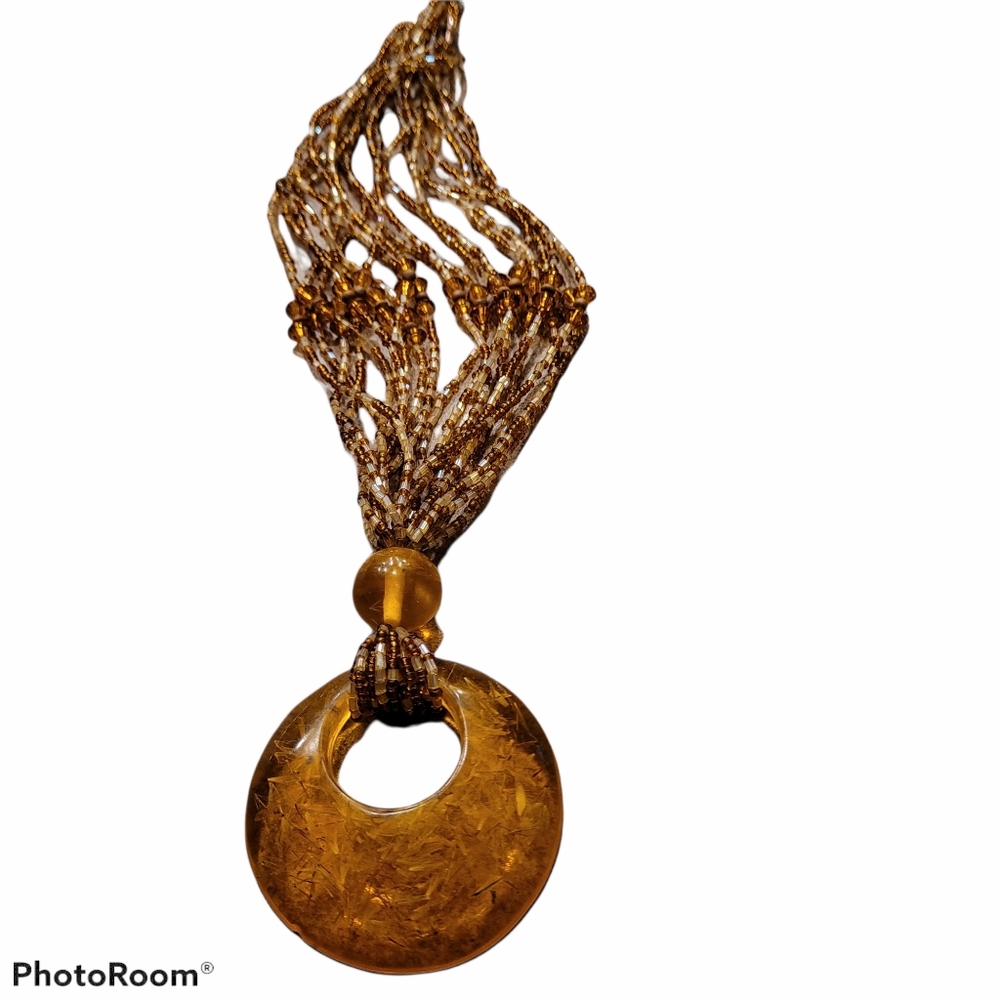 Gold necklace. Circle with seabeeds.